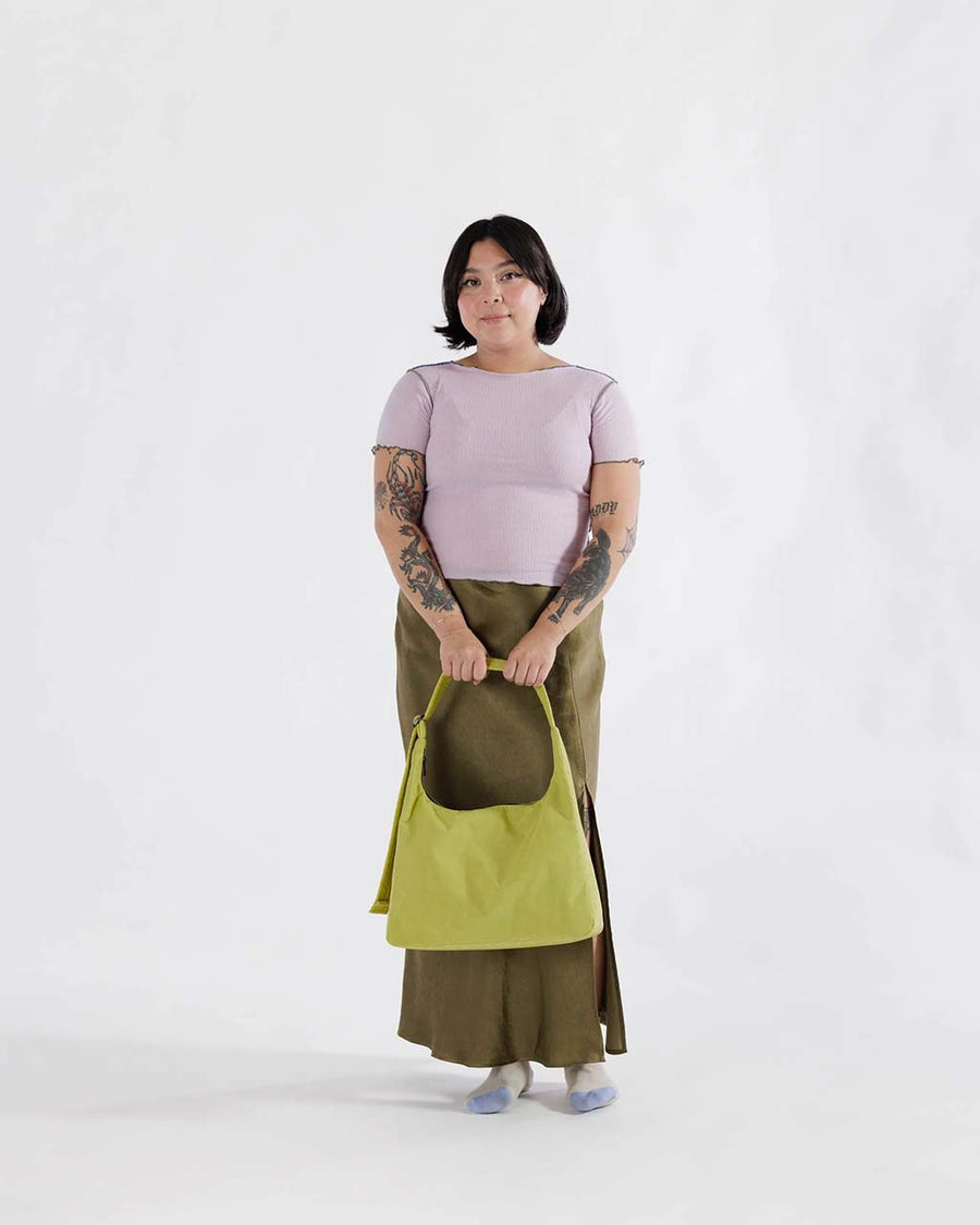 model holding lemongrass nylon shoulder bag