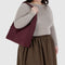 model carrying mahogany nylon shoulder bag with matching adjustable strap and zipper