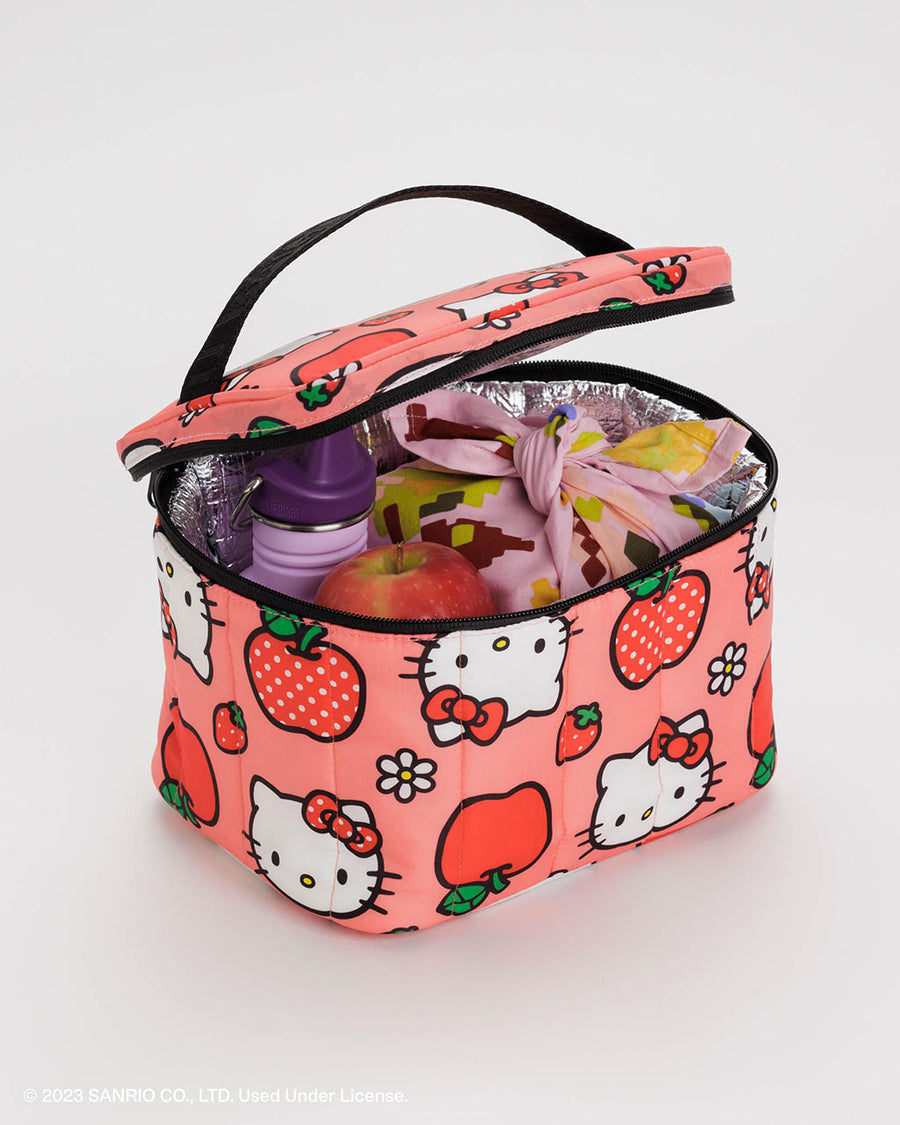 pink puffy baggu lunch box with hello kitty face, apple, and strawberry print with food inside