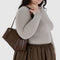 model carrying medium brown recycled dome bowler bag with silver charm clasp