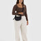 model wearing black small nylon crescent bag with silver holographic stars