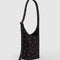 side view of black small nylon sling bag with red painted wildflower print