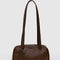 brown small dome recycled leather bowler bag with silver charm clasp