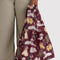model holding maroon standard baggu with fancy dog print