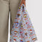 model holding light blue standard baggu with hello kitty and friends western print