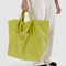 model holding lemongrass travel cloud bag