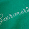 up close of green sweatshirt with white chainstitch farmer's market across the front