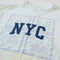 up close of white upcycled tee with navy NYC across the front