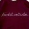maroon sweatshirt with white chainstitch trinket collector across the front