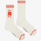 white crew socks with red trim and red 'joy' on the cuff
