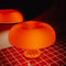 lit orange retro inspired mushroom lamp