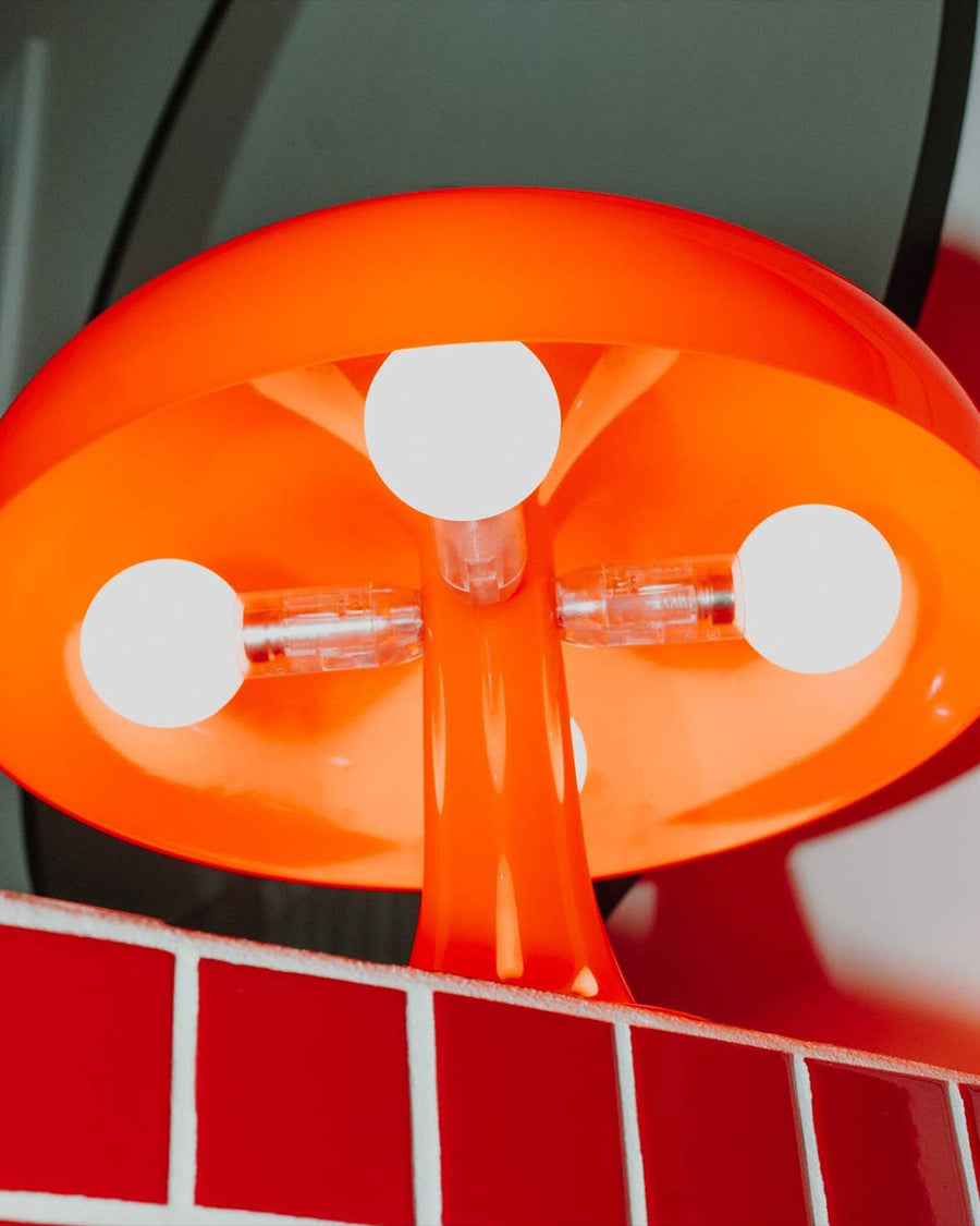 bulbs of lit orange retro inspired mushroom lamp