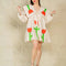 model wearing cream mini dress with exaggerated collar, puff long sleeves and all over abstract tulip print