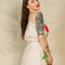 back view of model wearing cream cropped tank top with elastic top and bottom and red abstract tulip print and matching skirt