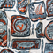 up close of white tea towel with orange and blue sardine can print