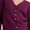 up close of model wearing fuzzy burgundy cardigan with colorful button front