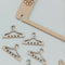 up close of wooden cutout stud and dangle earring holder with removable little hangers