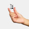 model holding double sided mini claw with white and black polka dots and black and white stripes