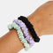 mint, black, and lavender mini silk scrunchies on models wrist