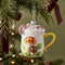 retro mushroom mug with hot cocoa drink inside hanging from a tree