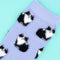 up close of lavender socks with fuzzy black and white cat print
