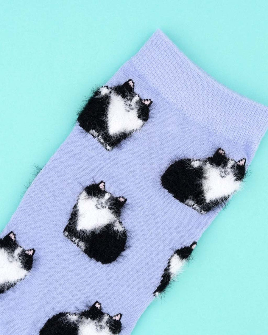 up close of lavender socks with fuzzy black and white cat print