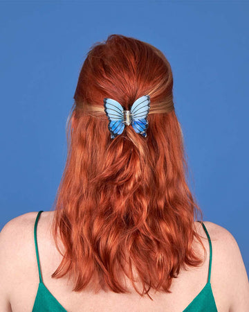 model wearing blue butterfly hair clip