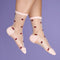 model wearing sheer socks with dainty lady bug print and cream trim