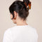 model wearing orange and tortoise shell moth hair clip