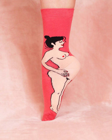 model wearing pink socks with pregnant woman design on them