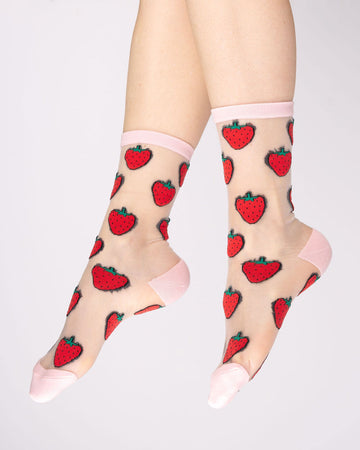 model wearing sheer socks with all over strawberry print and pink trim
