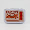 tin with matchbook print with tiger with CREATIVE SPARK!
