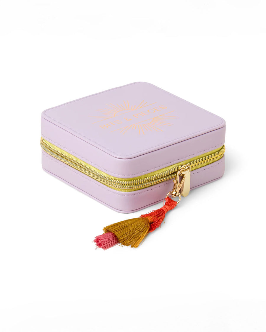 side view of purple jewelry case with multicolor tassel and gold 'bits & pieces' across the front