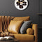 white round wall clock with large black numbers with yellow and red hands on a living room wall