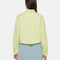 back view of model wearing cropped pale green button up top woth collar and extended front patch pockets