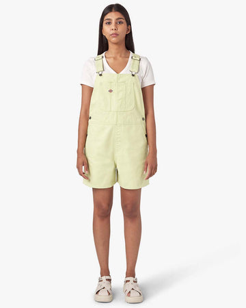 model wearing pale green shortalls with dickies patch on the front bust pocket
