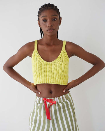 model wearing yellow knit cropped tank