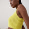 side view of model wearing yellow knit cropped tank