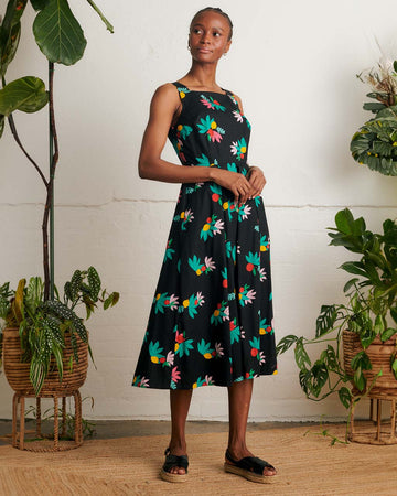 model wearing black tank midi dress with colorful summer fruit print