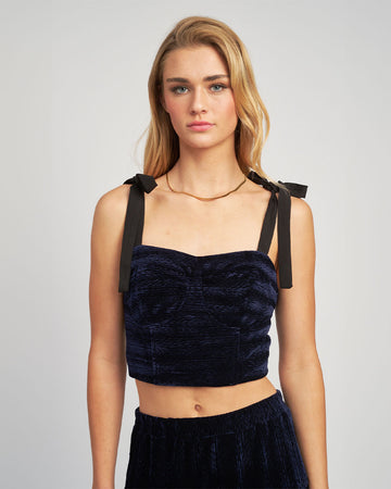 model wearing navy velour cropped bustier tank with black tie straps