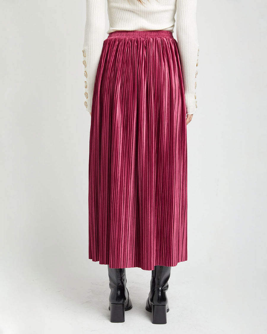 back view of model wearing mulberry silky pleated midi skirt