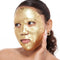 model with a gold foil sheet mask on their face