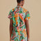 back view of model wearing short sleeve button down with vibrant banana print