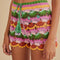 up close of model wearing colorful crochet shorts with crochet tie and scalloped hem