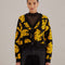 model wearing black cropped cardigan sweater with yellow abstract banana print