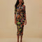 model wearing black midi dress with quarter length sleeves and vibrant foliage print