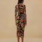 back view of model wearing black midi dress with quarter length sleeves and vibrant foliage print