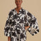 model wearing black and white palm tree kimono top and matching shorts