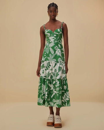 model wearing green and white patchwork midi dress with tropical leaf print and tiered skirt
