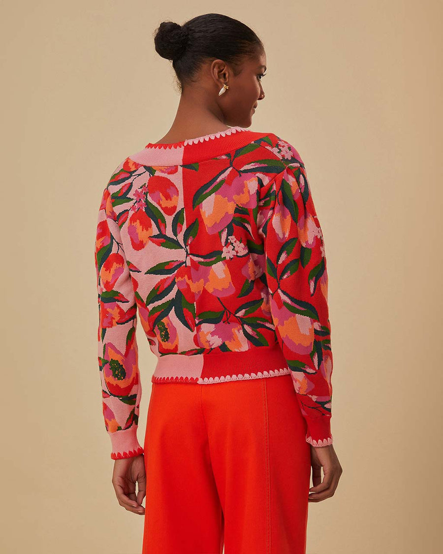 back view of model wearing two tone cropped cardigan with red papaya and pink papaya